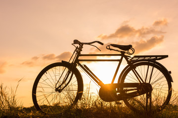 Naklejka na ściany i meble beautiful landscape image with Bicycle at sunset