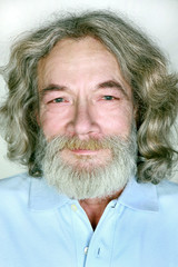 grandfather with a beard and long hair smiles