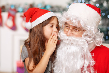 Pretty girl sitting with Santa 