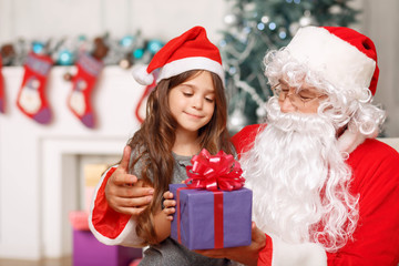 Pretty girl sitting with Santa 