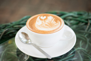 hot milk art coffee on  modern table