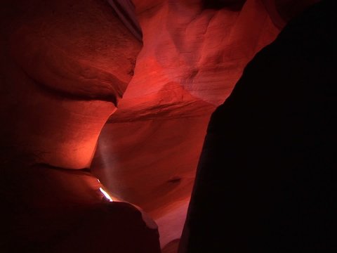 Medium-shot of a light beam illuminating an interior space in Antelope Canyon, Arizona.
