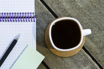 black coffee and notebook on the table