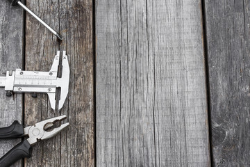 Different construction equipment on a wooden background