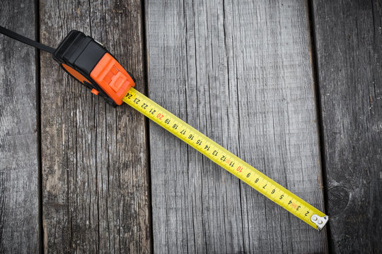 Measuring tape on a wooden board