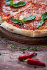 Italian pizza with basil leaves