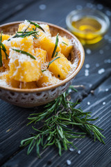 Crunchy croutons in bowl with rosemary