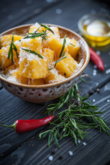 Crunchy croutons in bowl with rosemary