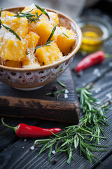 Crunchy croutons in bowl with rosemary