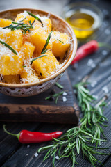 Crunchy croutons in bowl with rosemary