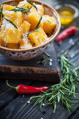 Crunchy croutons in bowl with rosemary