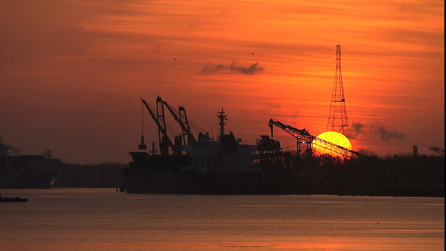 Savannah River Sunrise behind ships loading