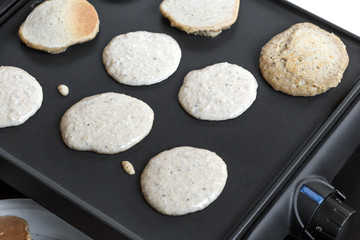 Fototapeta na wymiar Oat pancakes cooking on electric barbecue