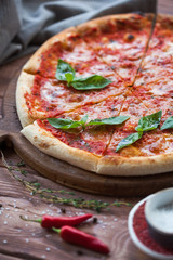Italian pizza with basil leaves