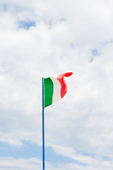 Italian flag in cloudy sky