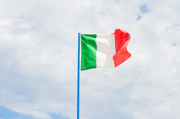 Italian flag in cloudy sky