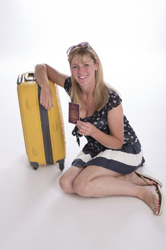 Woman holidaymaker with suitcase and passport