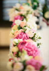 Tender flower composition with peonies and roses for an event, party or wedding reception
