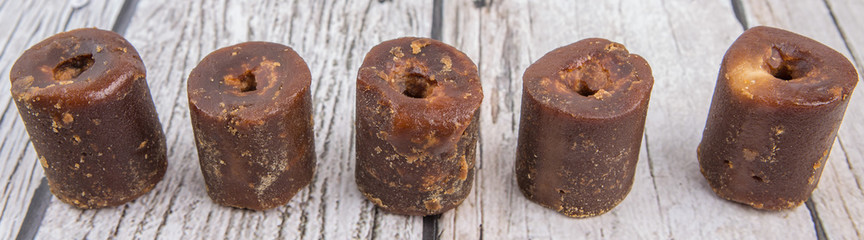 Brown coconut sugar over wooden background