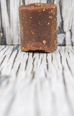 Brown coconut sugar over wooden background
