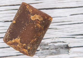 Brown coconut sugar over wooden background