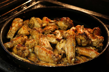 Chicken wings are baked in the oven