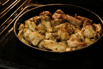 Chicken wings are baked in the oven