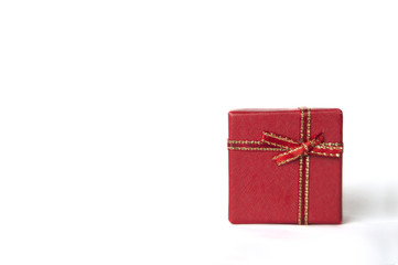 Red gift box isolated on white background. Left copyspace.