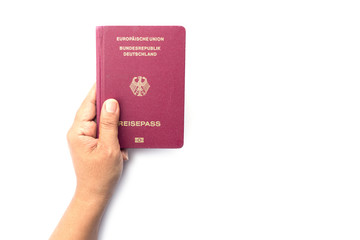 Close up hand holding German passport isolated on white