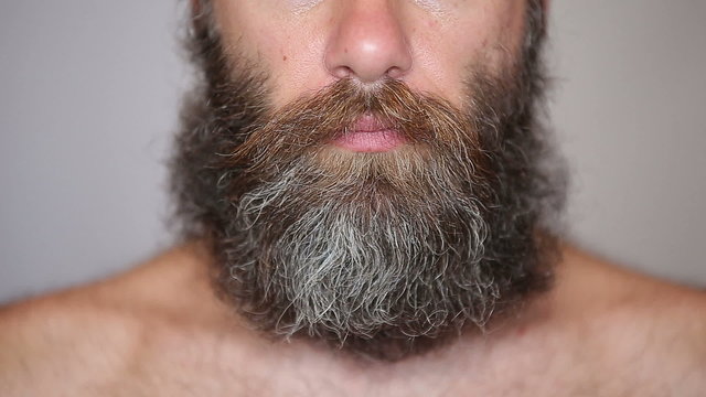 White Man Taking Care of his Lush Beard and Mustache