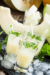 Fresh juice from the pulp of a melon, mint, ice and striped stra