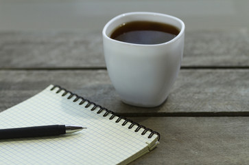black coffee and notebook on the table