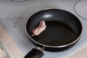 Cooking Pork Meat on a Frying Pan with Oil