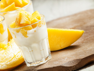 Homemade yogurt with fresh mango slices, selective focus