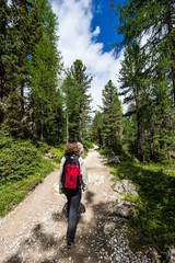 Fototapeta na wymiar woman walking on a path in the woods