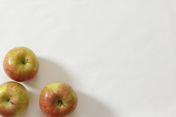 Background of apples on a white table cloth