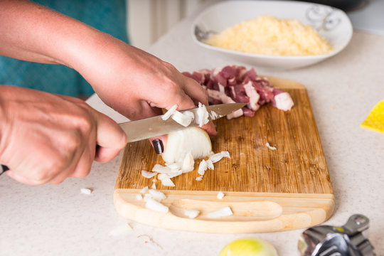Chef cutting up a fresh onion