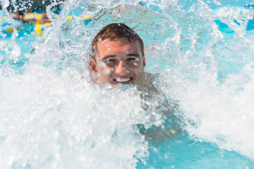 Young Man Enjoying Waves in Outdoor Wave Pool