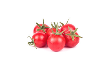 Several fresh small red cherry tomatoes with drops on a white background