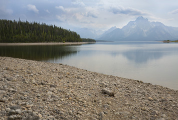 Gravel beach, mountains at Jackson Lake, Teton National Park, Wy
