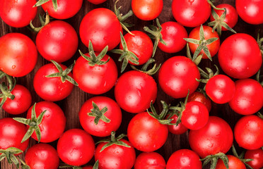 Scattered small fresh cherry tomatoes with drops close-up