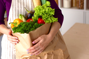 Healthy positive happy woman holding a paper shopping bag full