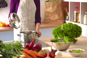 Young Woman Cooking in the kitchen. Healthy Food