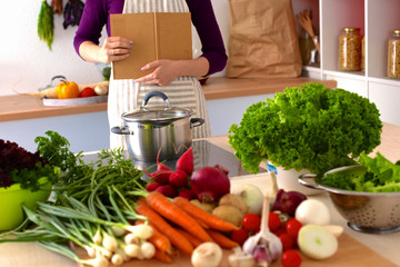 Young Woman Cooking in the kitchen. Healthy Food