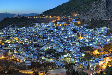 Evening view of Chefchaouen medina quarter with buildings painted in blue color from the hill of...