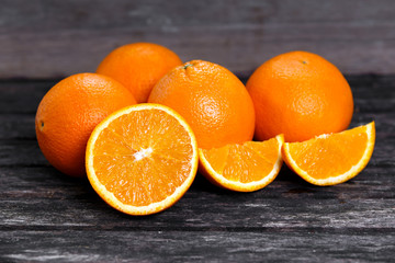 Beautiful Oranges Fruit Full and Sliced on old wooden table. rich with vitamins. background, texture