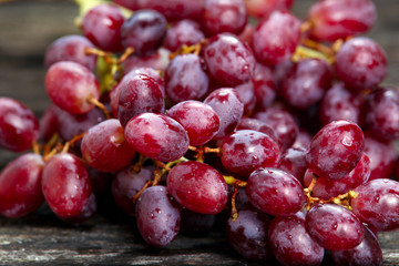 Red grape with water drops, close up background. selected focus