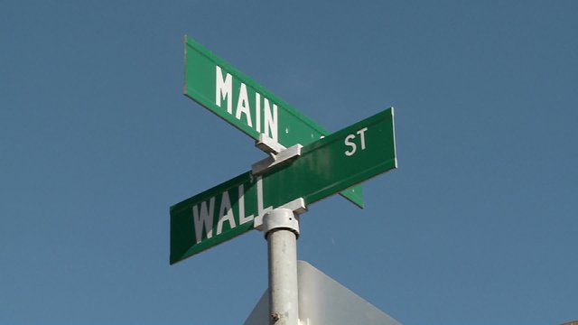 A street sign indicates the intersection of Main and Wall Streets.