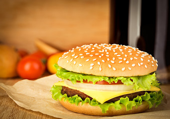 Delicious hamburger on brown paper on a wooden tabletop