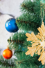 Obraz na płótnie Canvas colored toys on branches of an artificial Christmas tree